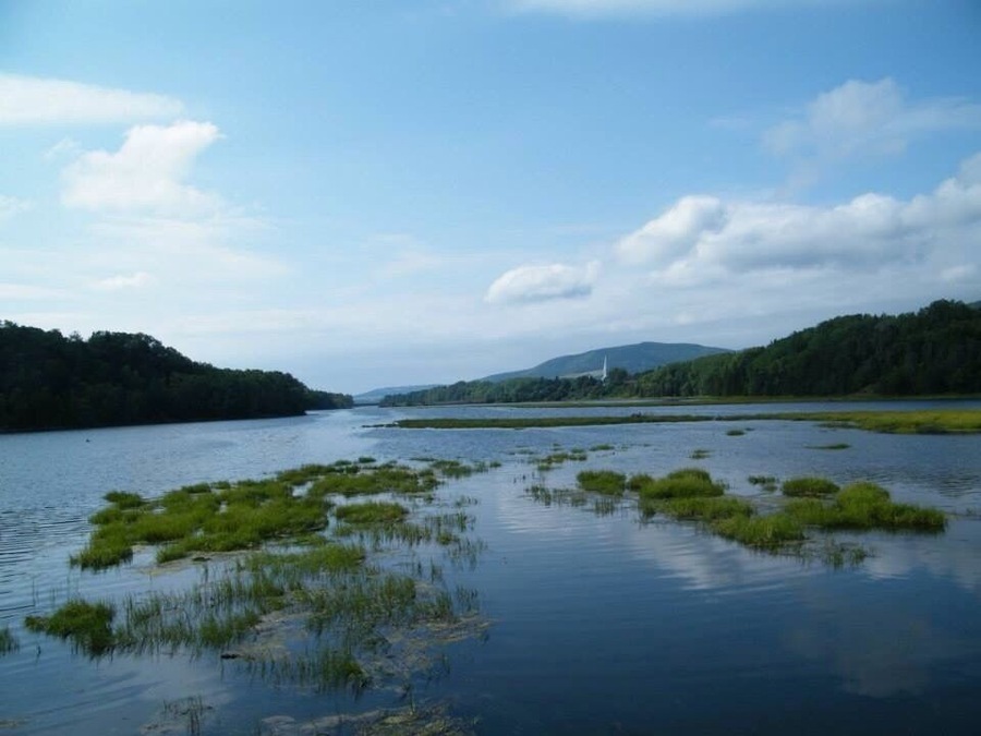 A beautiful walking trail along the inner section of the Mabou Inlet. Bald eagles are often spotted along this trail. This view looks back across the inlet towards the town of Mabou and its striking church spire.