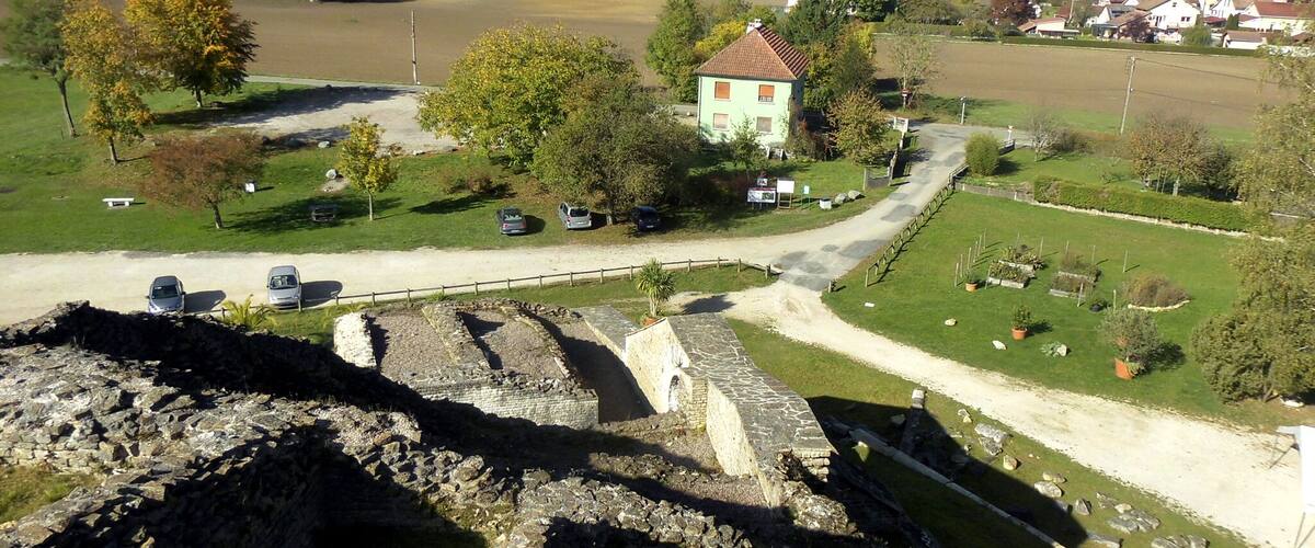 A rural landscape with a stone bridge, a small house, and a cemetery.
