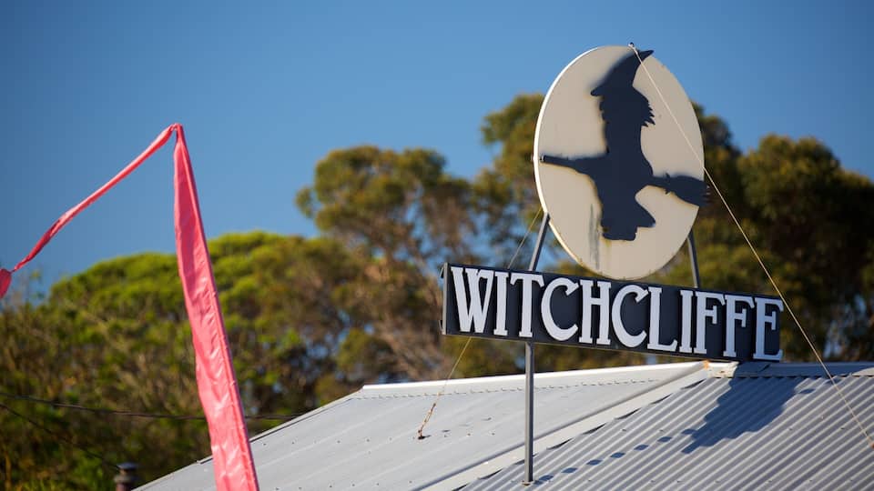 A sign with the name 'WITCHCLIFFE' and a silhouette of a witch on a circular sign.