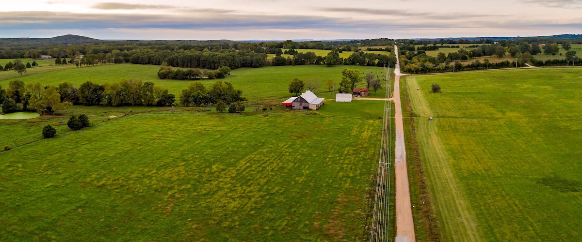 Aerial landscape of barn and homestead along a country road