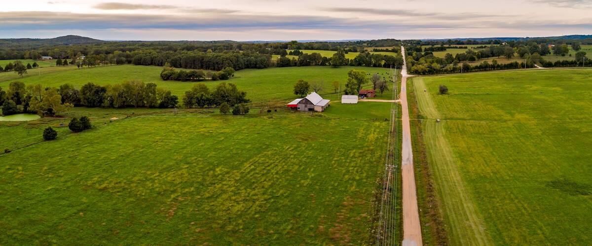 Aerial landscape of barn and homestead along a country road