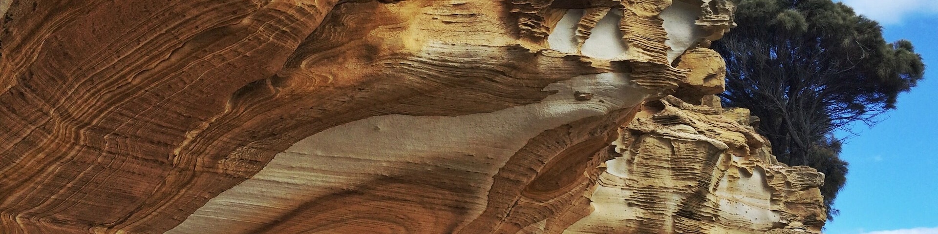 A ferry out of Triabunna. A cycle from Darlington. A hop, skip and a jump across the rocks. Then you've placed yourself nicely in front of all the Painted Walls of Maria Island in Tasmania - just check its low tide first for the best viewpoints!