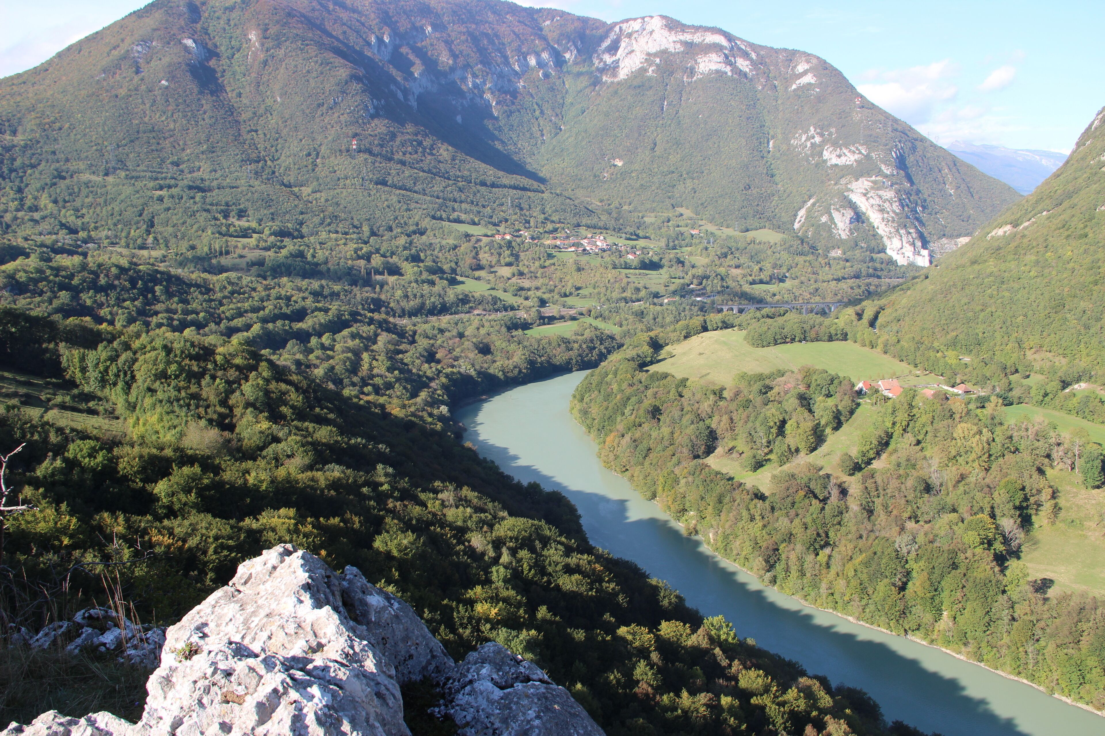 A river winding through a valley with mountains in the background.