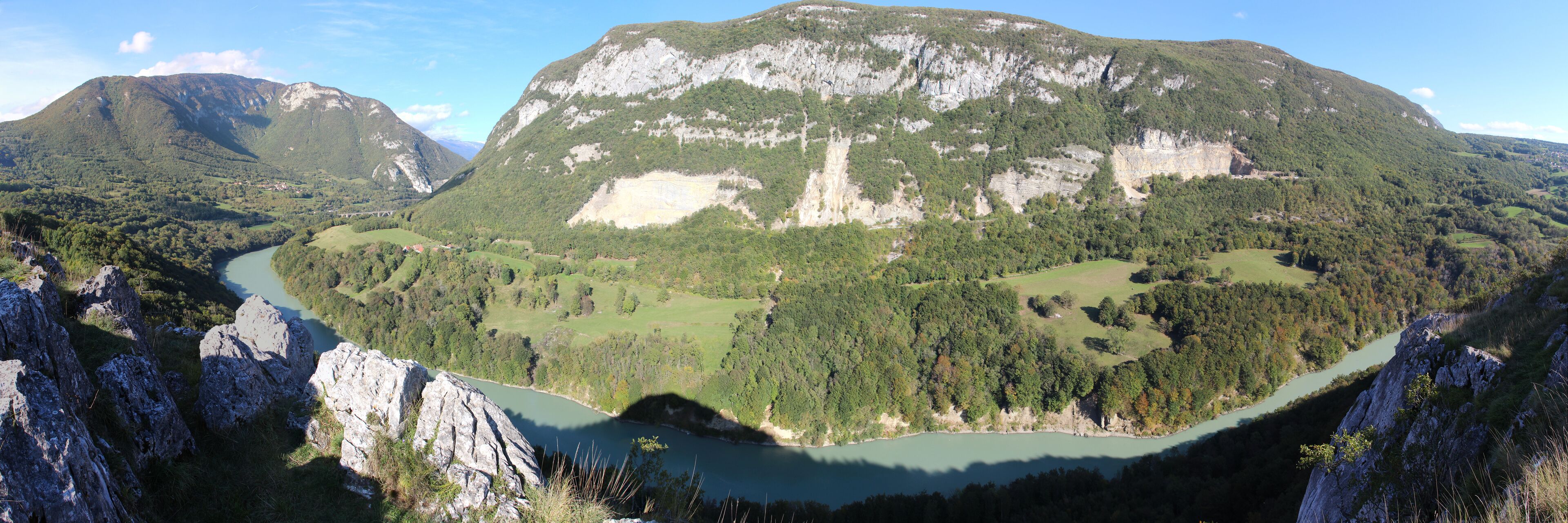 A mountainous landscape with a river winding through a valley.