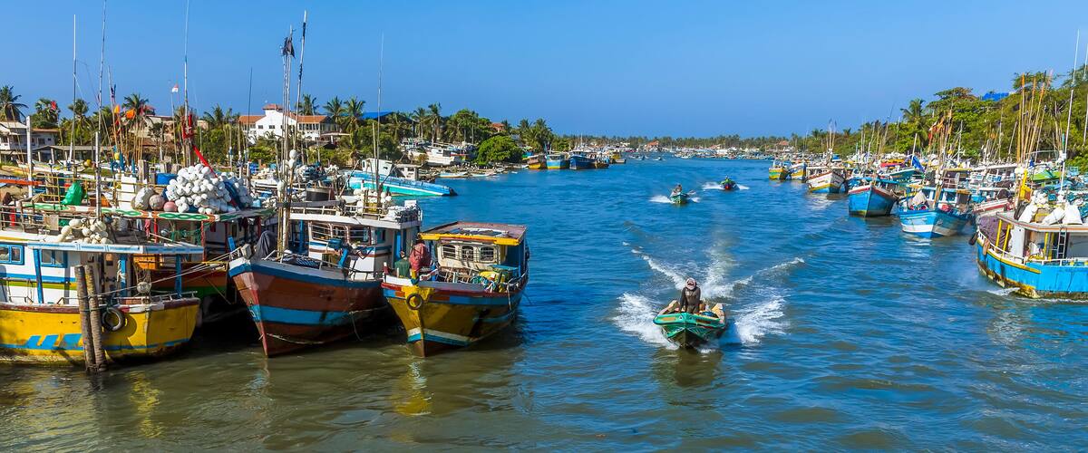 Fishing boats speeding home into the lagoon in Negombo, Sri Lanka