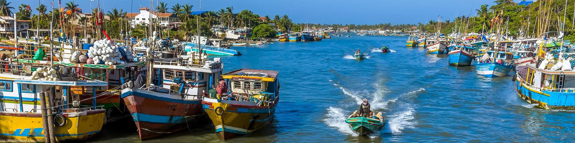 Fishing boats speeding home into the lagoon in Negombo, Sri Lanka