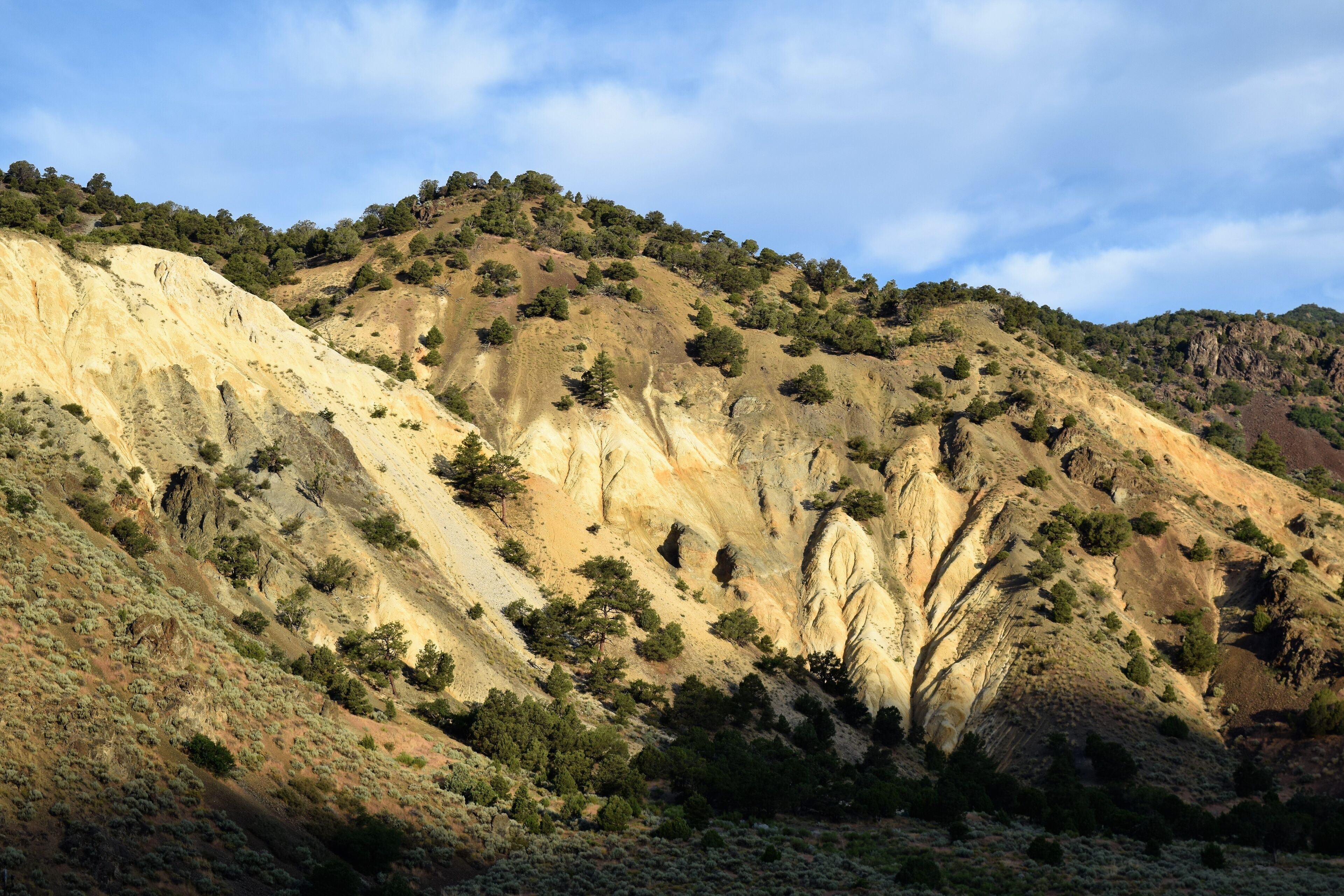 Early Morning Hills Light up near Marysvale, Utah while Darkening Skies Cast Shadows