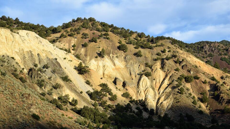 Early Morning Hills Light up near Marysvale, Utah while Darkening Skies Cast Shadows