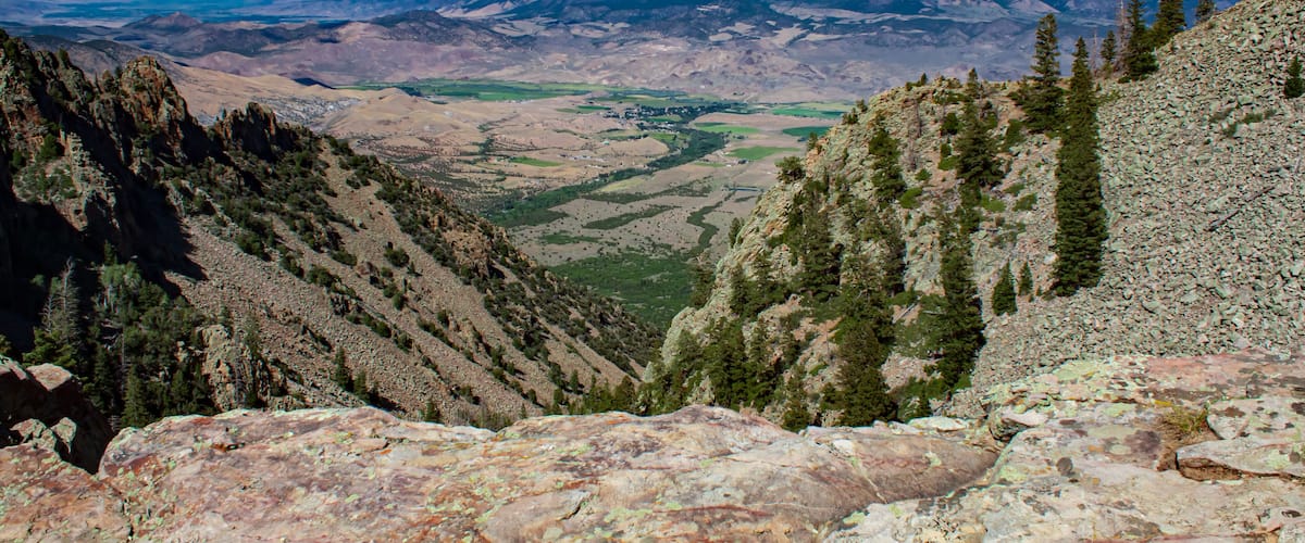 A mountainous landscape with rocky terrain and sparse vegetation.
