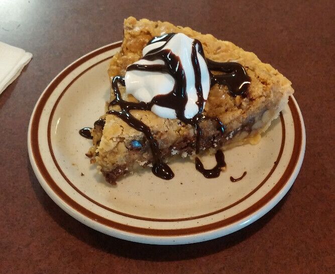 A slice of toll house pie! Essentially, a wedge of chocolate chip cookie served warm and topped with whipped cream and chocolate syrup! At least three of the ultra-friendly waitresses made a point to stop by and tell me that it was in house made and to make sure that my server had warmed it up for me.