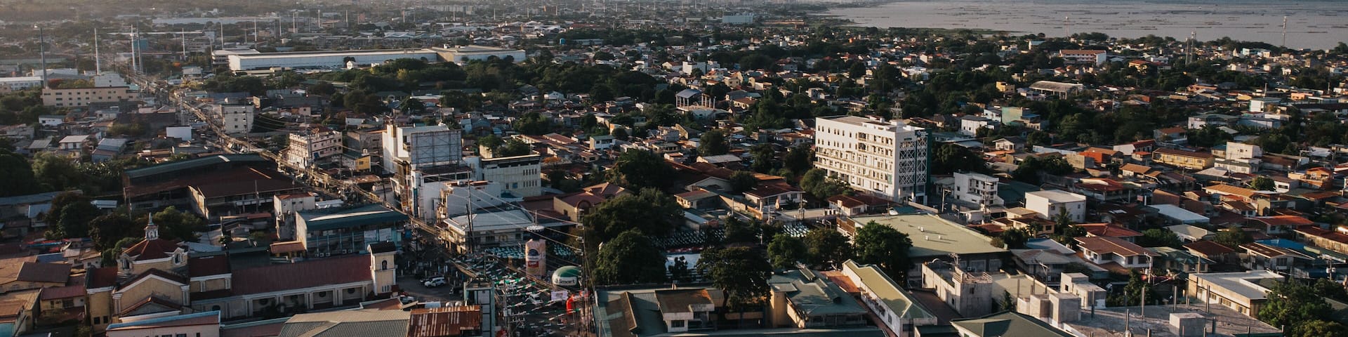 Aerial View of Dense Urban Sprawl and Busy Main Street under Dramatic Sky in San Pedro, Laguna, Philippines