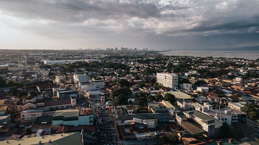 Aerial View of Dense Urban Sprawl and Busy Main Street under Dramatic Sky in San Pedro, Laguna, Philippines