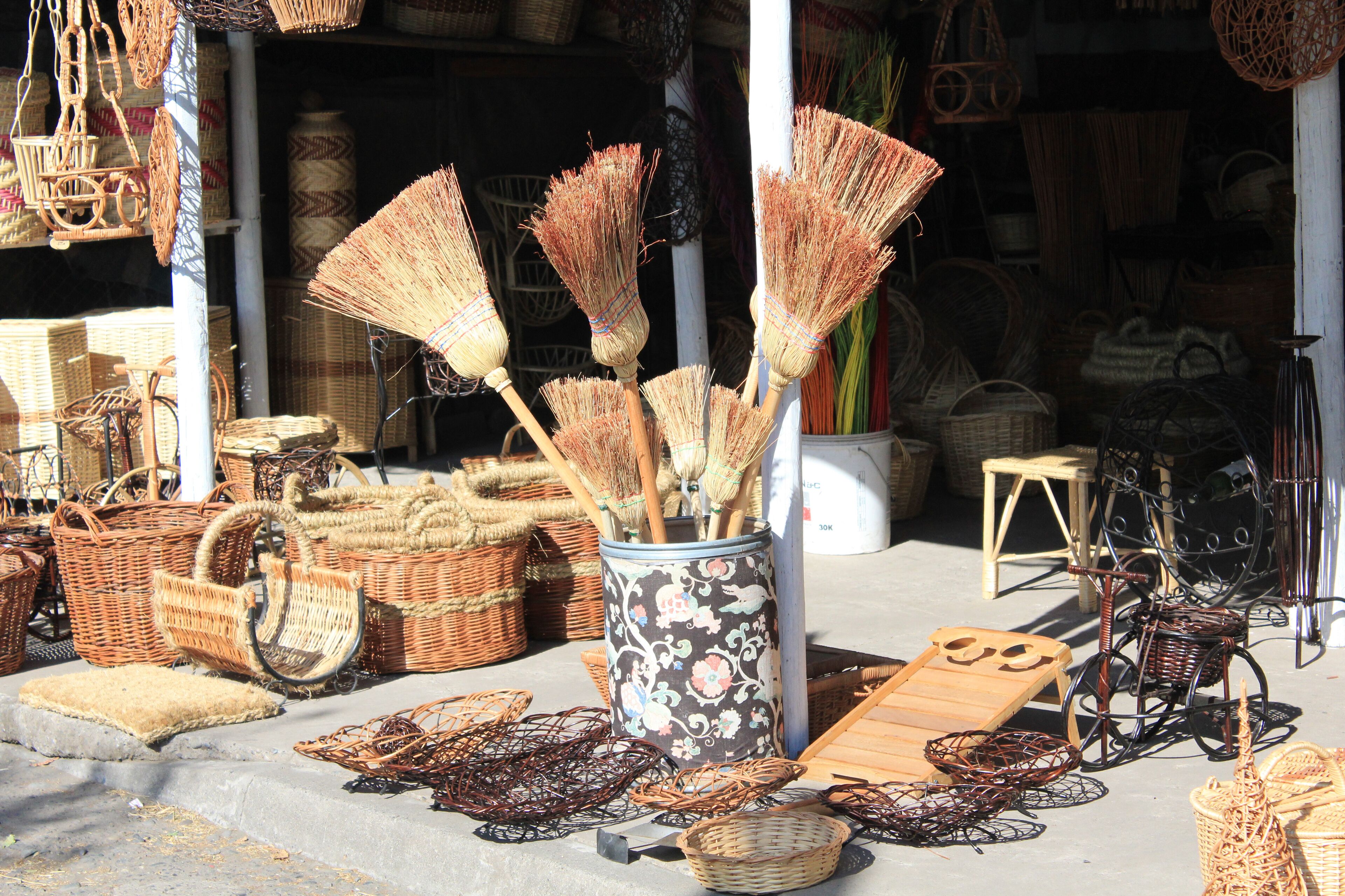 Wicker furniture and baskets displayed outside a shop.