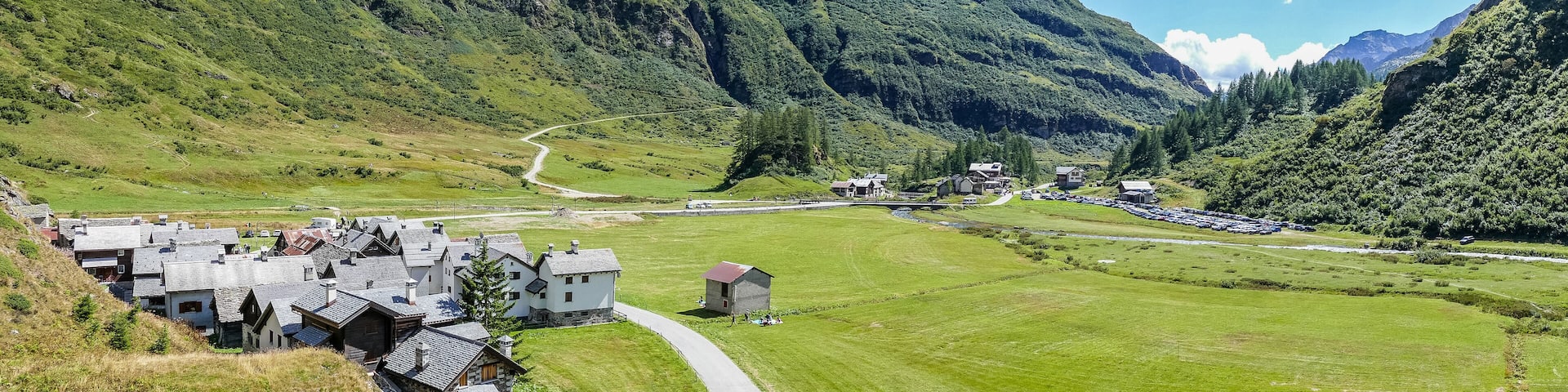 small village in the mountains with stone houses, flowers and a river in val formazza