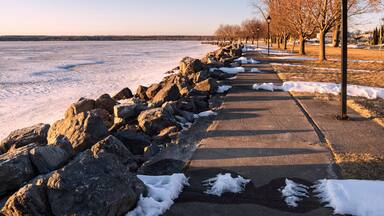 Spring View of Sylvan Beach Shoreline on Oneida Lake during Sunset while the Lake is Still Frozen.