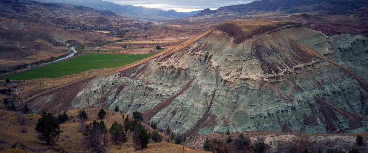 A rugged mountain landscape with a river flowing through a valley.