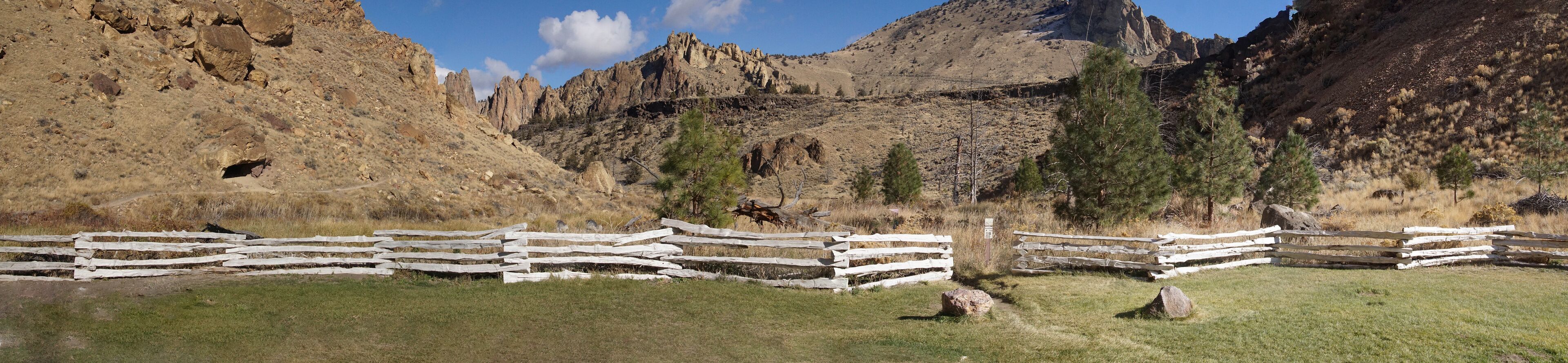 Split rail fence and jagged peaks