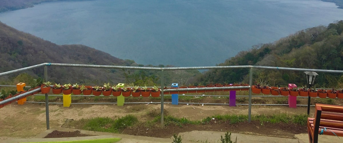 A large body of water surrounded by hills.