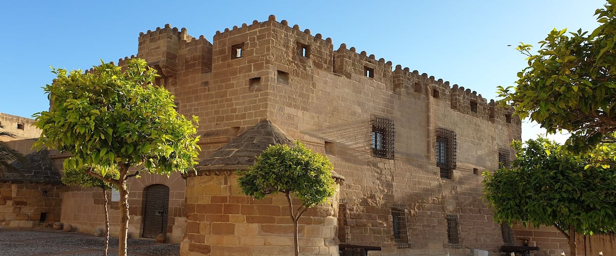 A historic stone castle with battlements and arched windows.