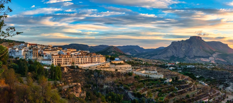Panoramic view of a white Andalusian village on the hill at sunrise, Velez Blanco, Almeria.