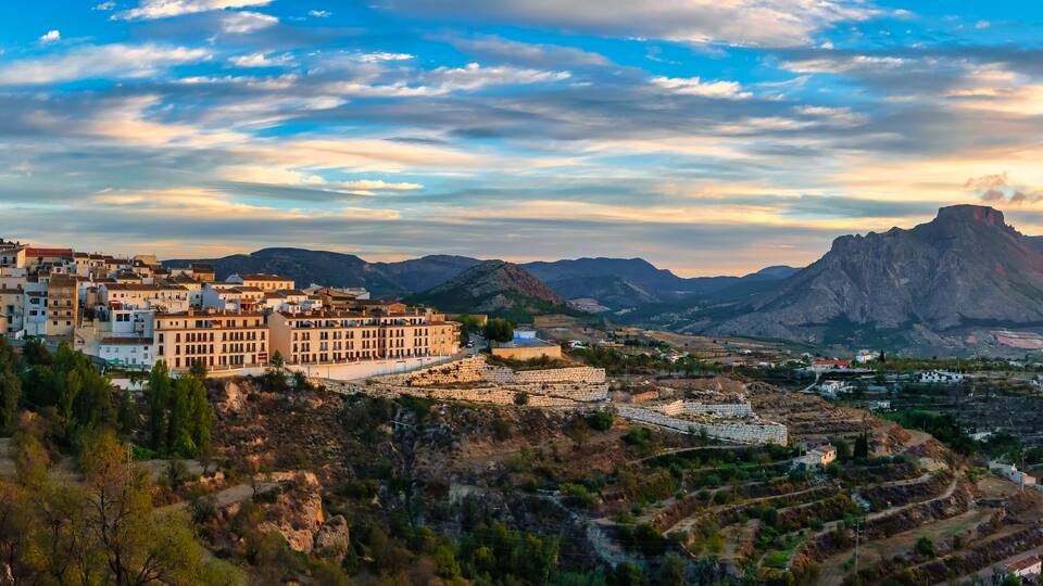 Panoramic view of a white Andalusian village on the hill at sunrise, Velez Blanco, Almeria.