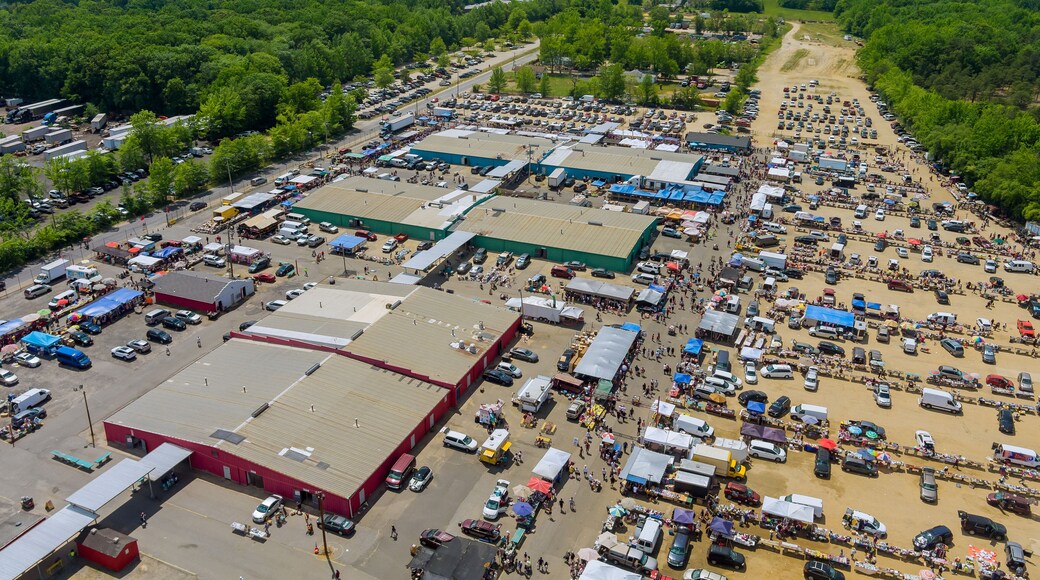Panorama view on flea market roof top with miscellaneous items and crowds of buyers and sellers in Englishtown NJ USA