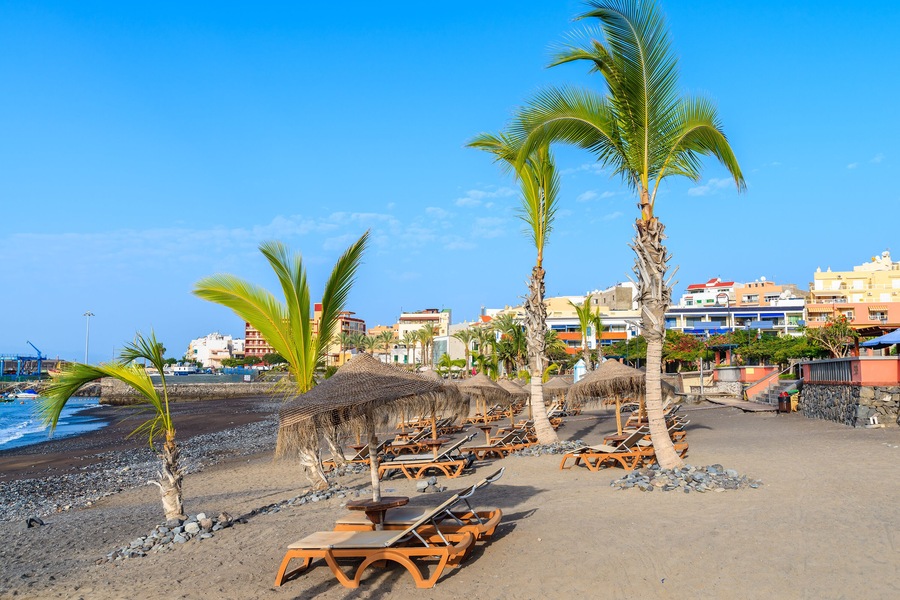 Palm trees on black sand volcanic beach in San Juan port, Tenerife island, Spain; Shutterstock ID 588059969; Purchase Order: SP-1394 HA Batch 3 Part 1; Order Number: ; Client/Licensee: HomeAway; Other