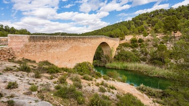 Antique one arch stone bridge over a river the Hoces del Rio Cabriel Natural Park between Valencia and Cuenca in Spain. Protected Area.
