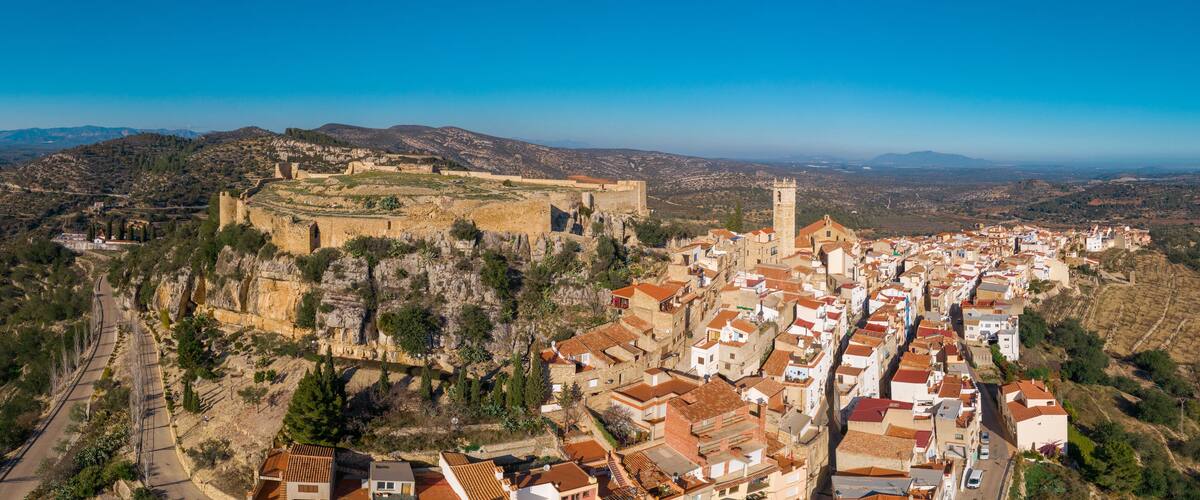 Aerial view of Cervera de Maestre castle with ruined excavated inner building remains surrounded by a partially restored outer wall of Arab origin