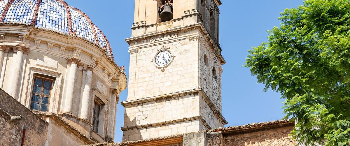 A historic church with a prominent bell tower and a dome.
