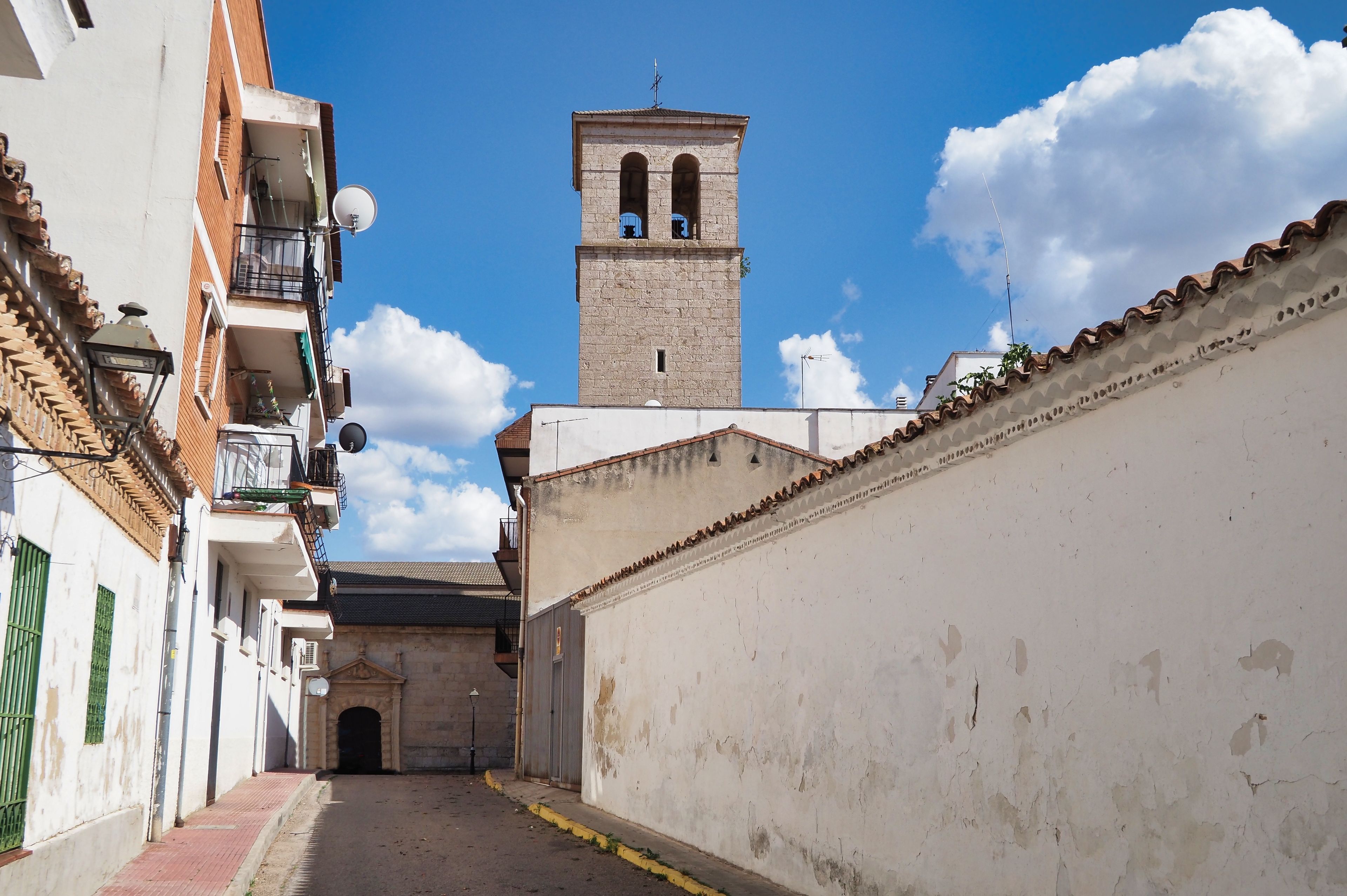 street of the town of loeches with the bell tower of the parish in the background