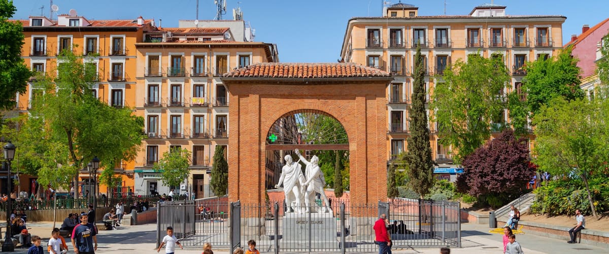 Malasana which includes a square or plaza and a statue or sculpture as well as children