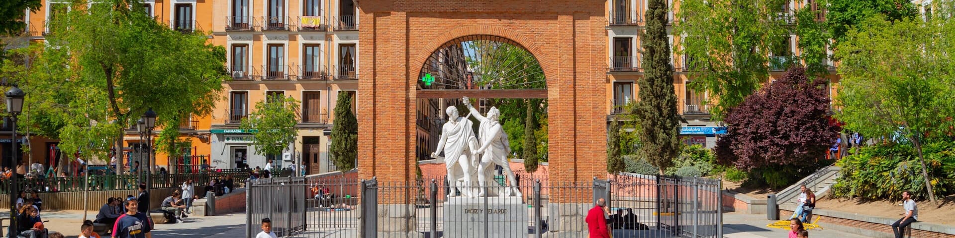 Malasana which includes a square or plaza and a statue or sculpture as well as children