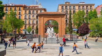 Malasana which includes a square or plaza and a statue or sculpture as well as children