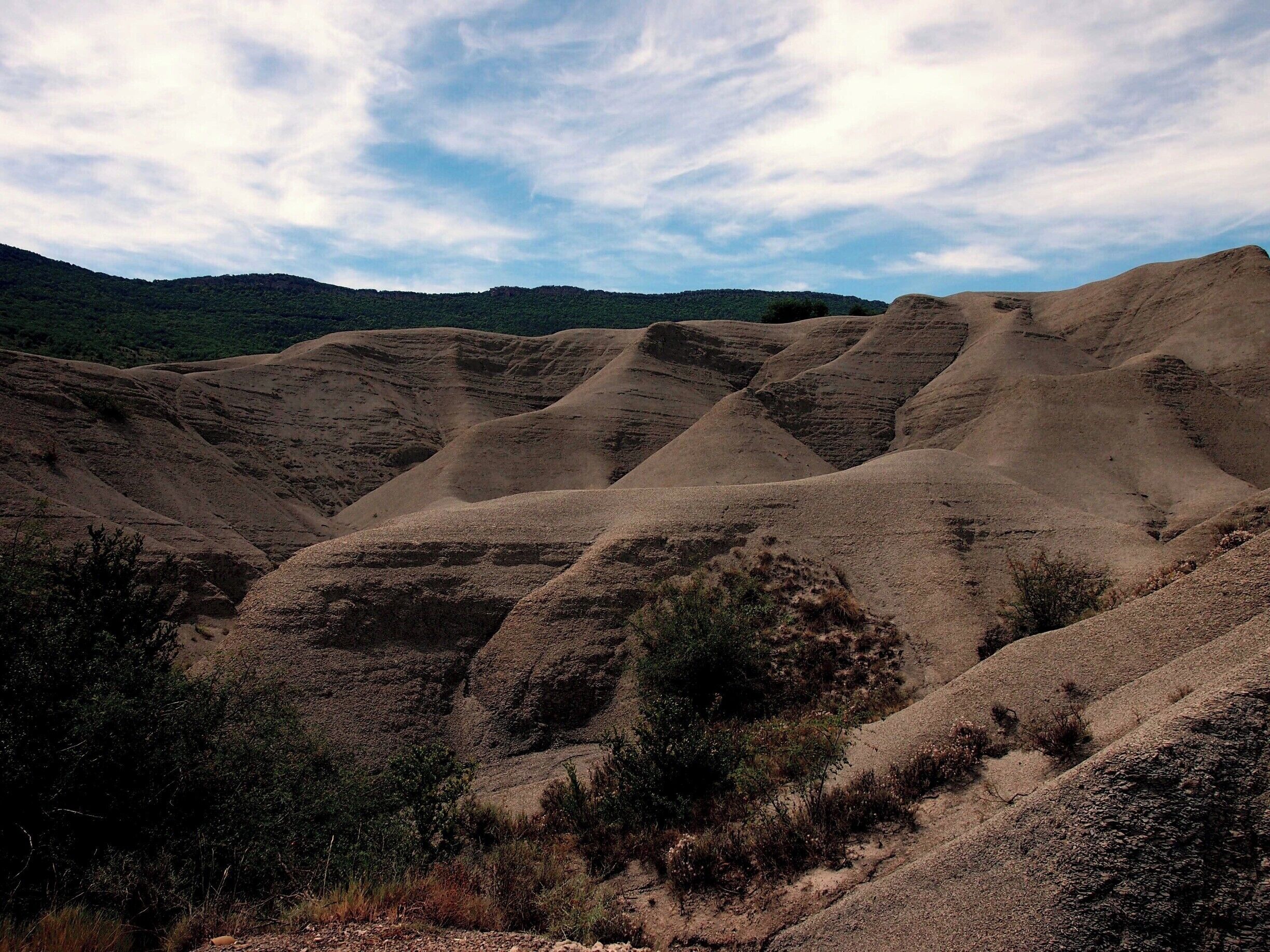 These strange hill formations seem like sand dunes, but are solid rock instead! Their strange shape is due to wind and rain erosion.
#caminodesantiago   

DAY 3 - RUESTA http://www.endoftherainbow.net/blogita/giorno5km53ruesta