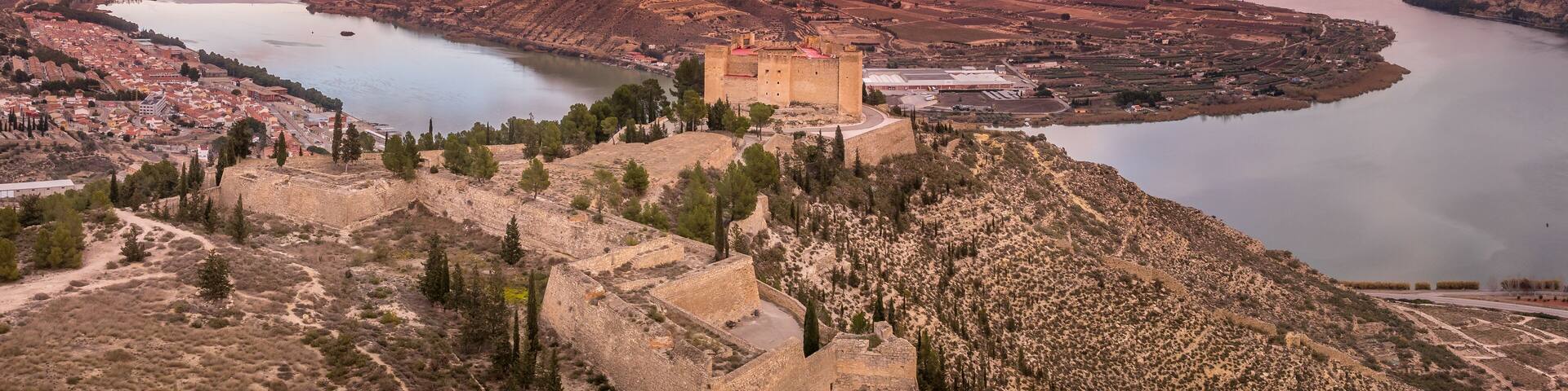 Mequinenza castle panoramic aerial view above the riba roja reservoir in Aragon Spain with dramatic colorful sky