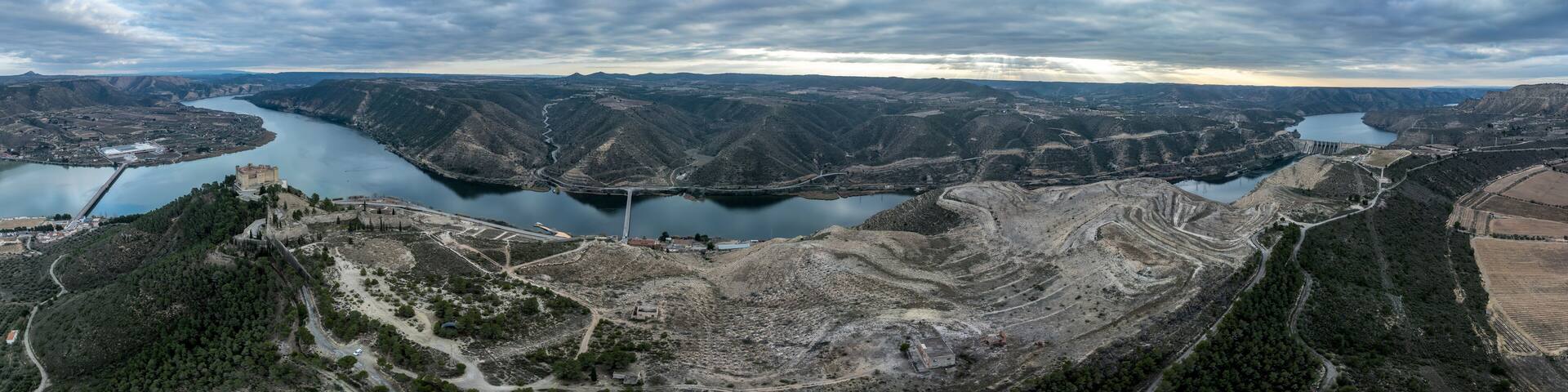 Mequinenza castle panoramic aerial view above the riba roja reservoir in Aragon Spain with dramatic colorful sky