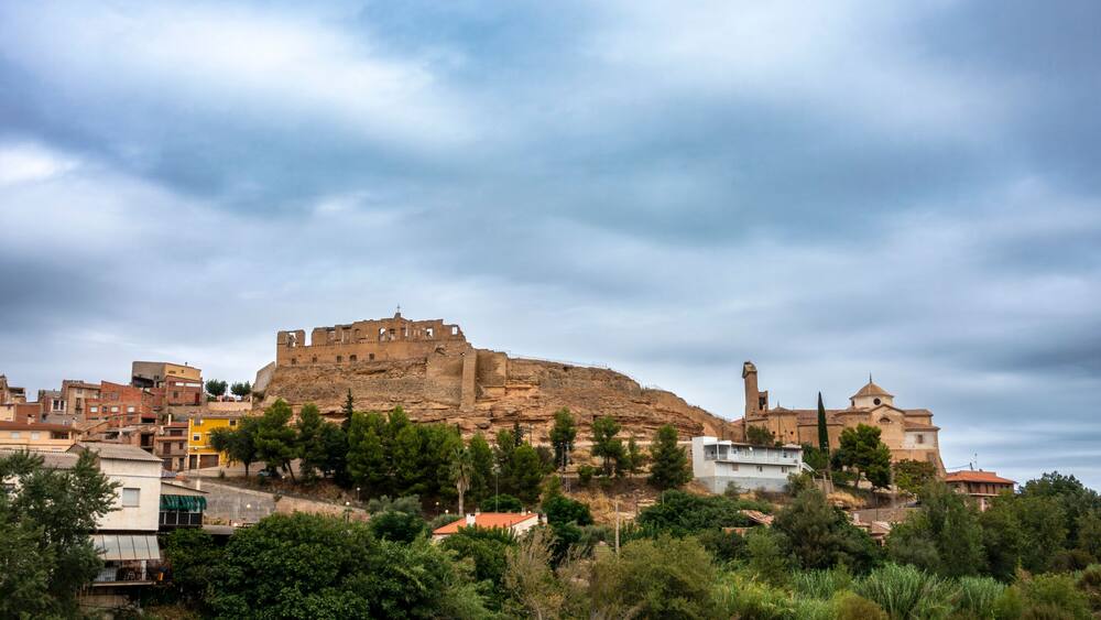 Ancient Medieval Skyline Maella Zaragoza Spain 14th Century Castle Fortress Ruins and Historic Gothic Church Townscape