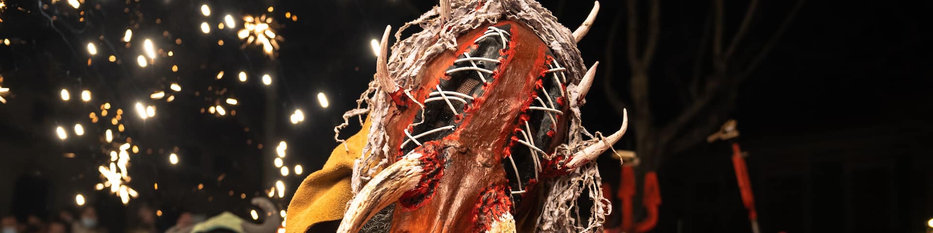 Valencia, Spain - 11 February, 2022: Man with a demon mask looking at camera in Spanish traditional festival, called Correfoc