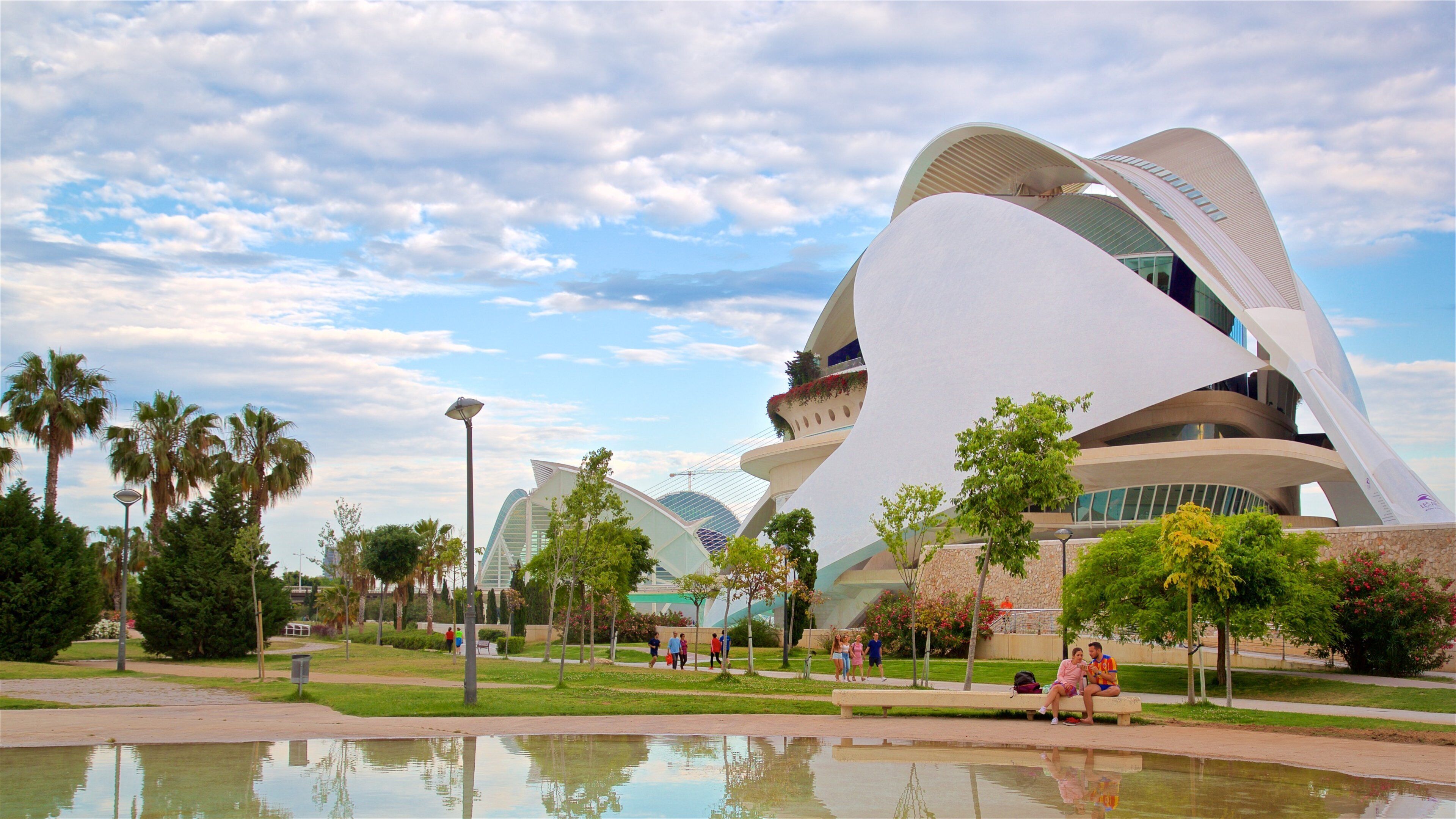 Camins al Grau which includes modern architecture, a park and a pond