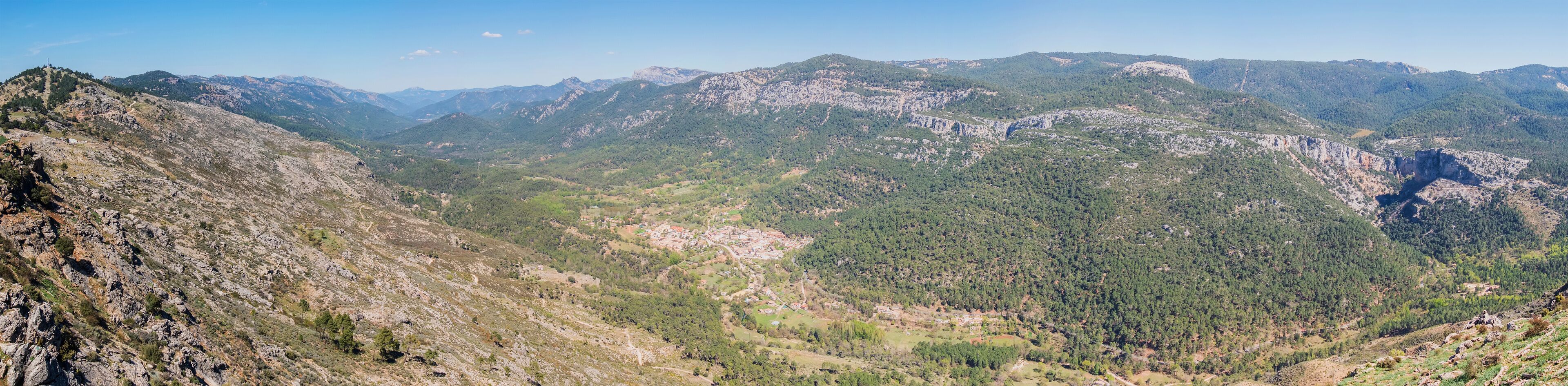 A mountainous landscape with rocky terrain and dense forests.