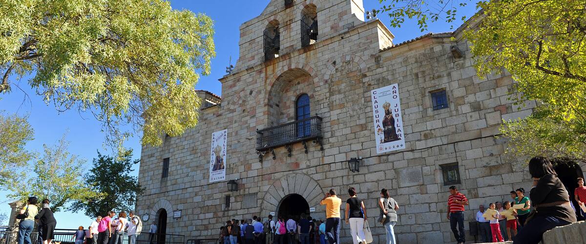 A historic stone building with a bell tower and arched windows.