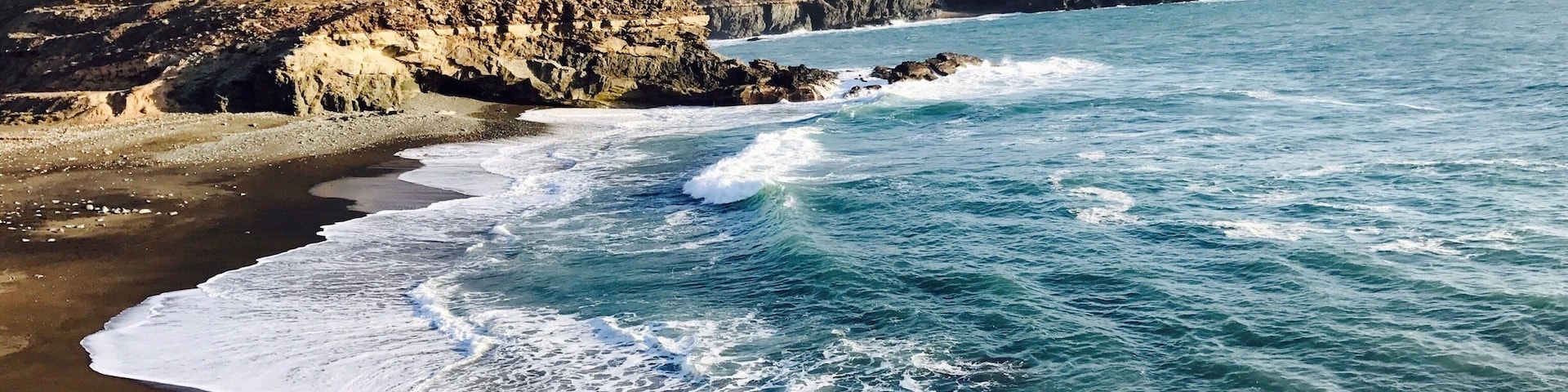 Black sand beach. A tiny town on Fuerteventura island. Not a lot people go there because you have to go through mountain road. But actually it is a very beautiful drive.