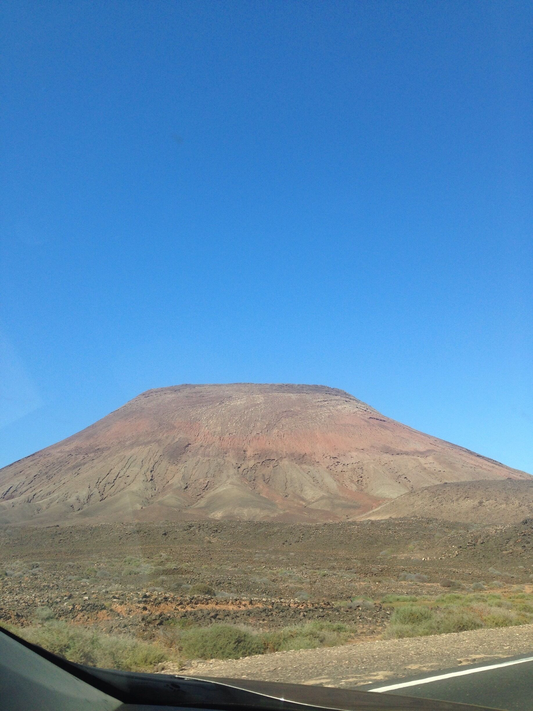 A mountain with a clear blue sky.