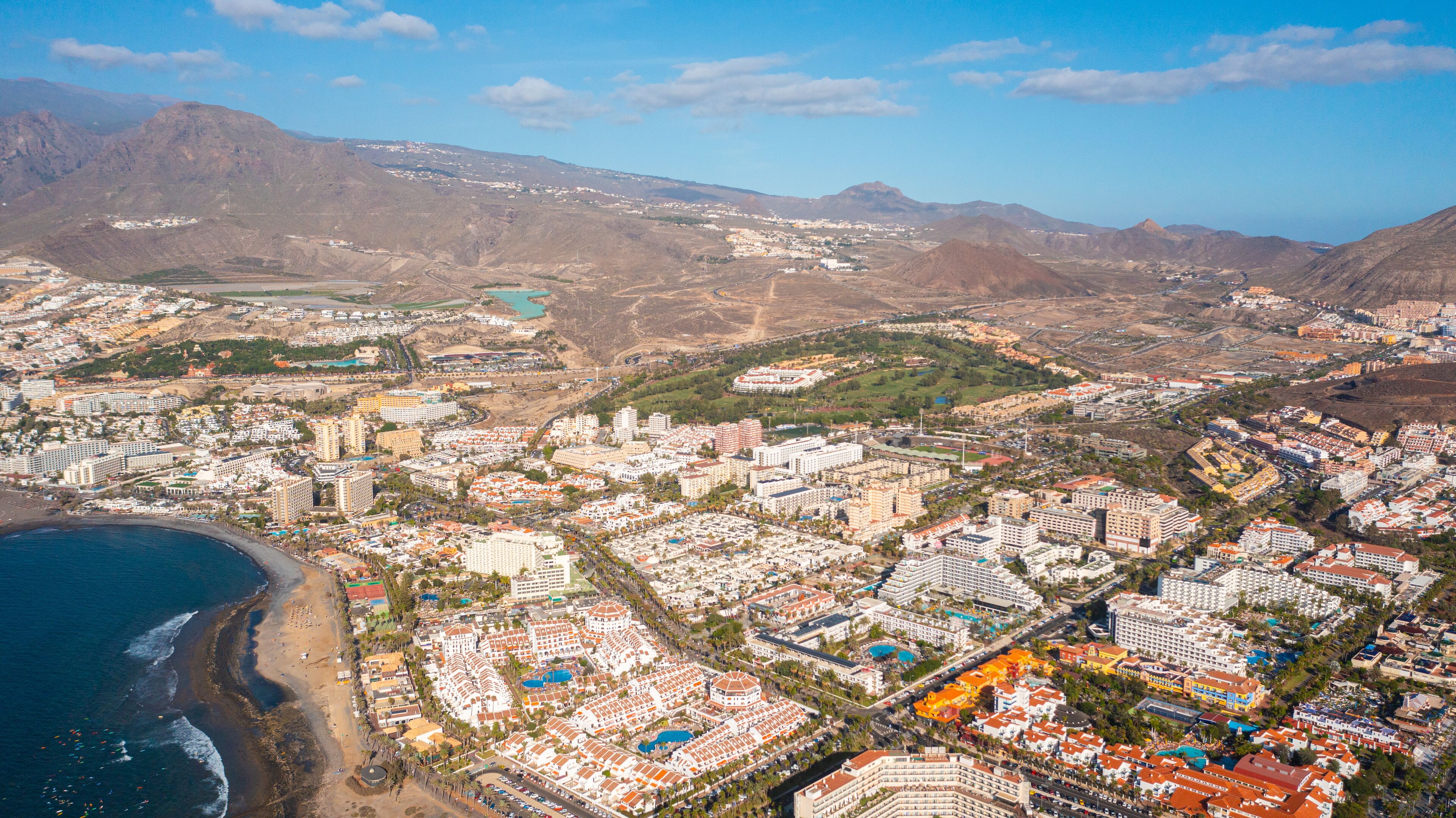 Aerial photo from drone to de Tenerife and beachs Adeje Playa de las Americas, Playa Honda,Playa de Troya, Playa de El Bobo.In the background Tenerife at sunset. Tenerife, Canary islands, Spain