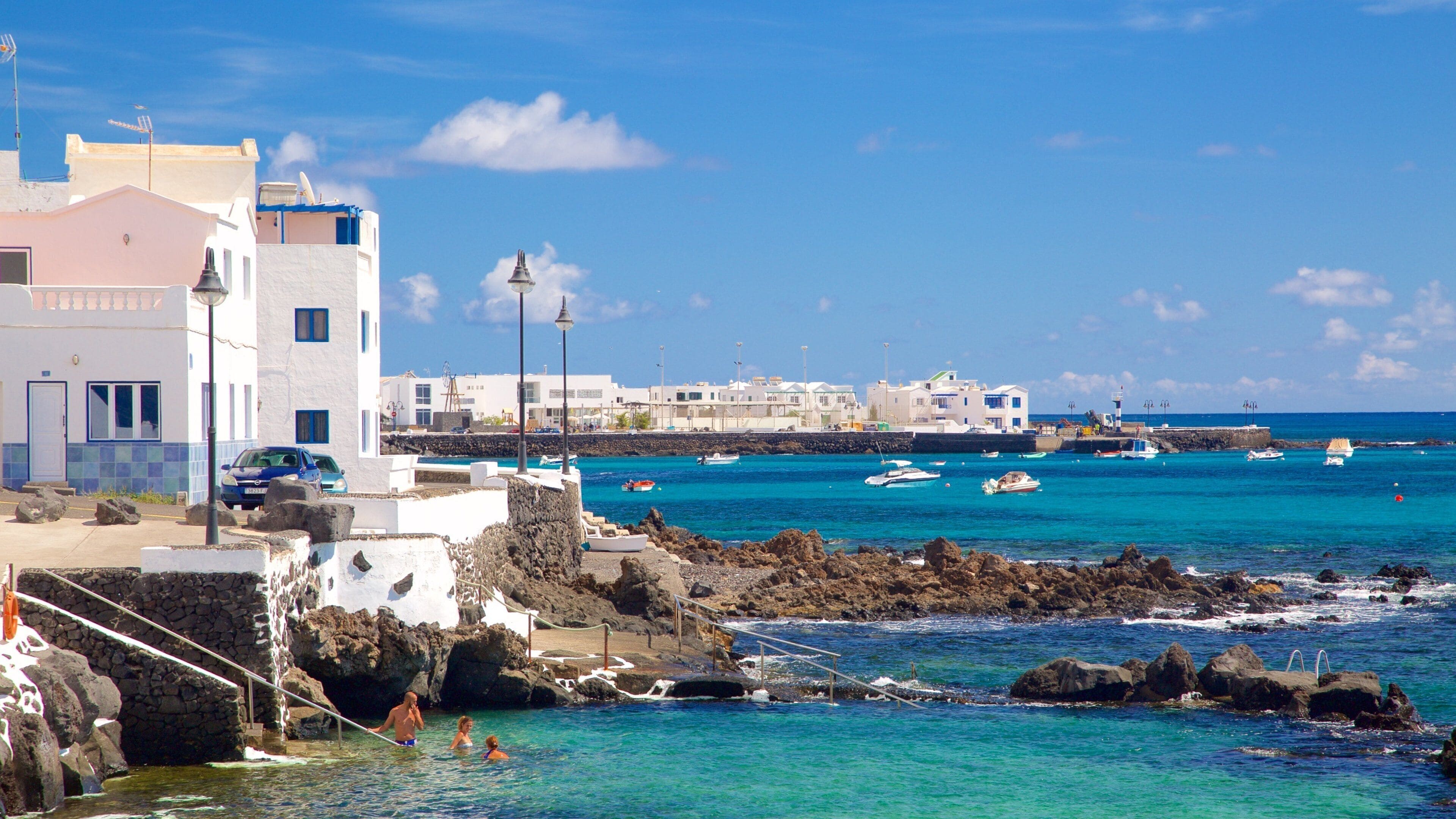 Lanzarote which includes general coastal views, a coastal town and rugged coastline