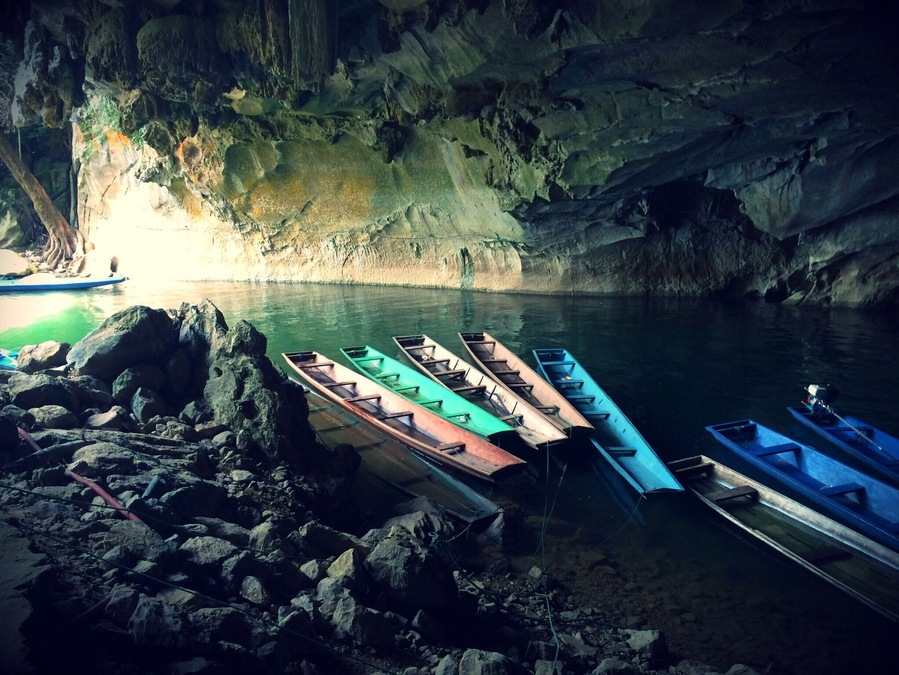 An unexpected destination during my trip to Laos. I ended up visiting Kong Lor Cave, located in the small village of Kong Lor, in central Laos. We entered the pitch black cave on a very basic long boat and a torch on our heads. You exit on the other side of the cave to a beautiful, lush green scenery where buffalos rest in the water, butterflies fill the air, and there's a perfect quietness.