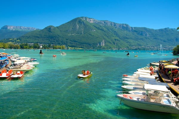 Lake Annecy which includes mountains, a bay or harbor and boating