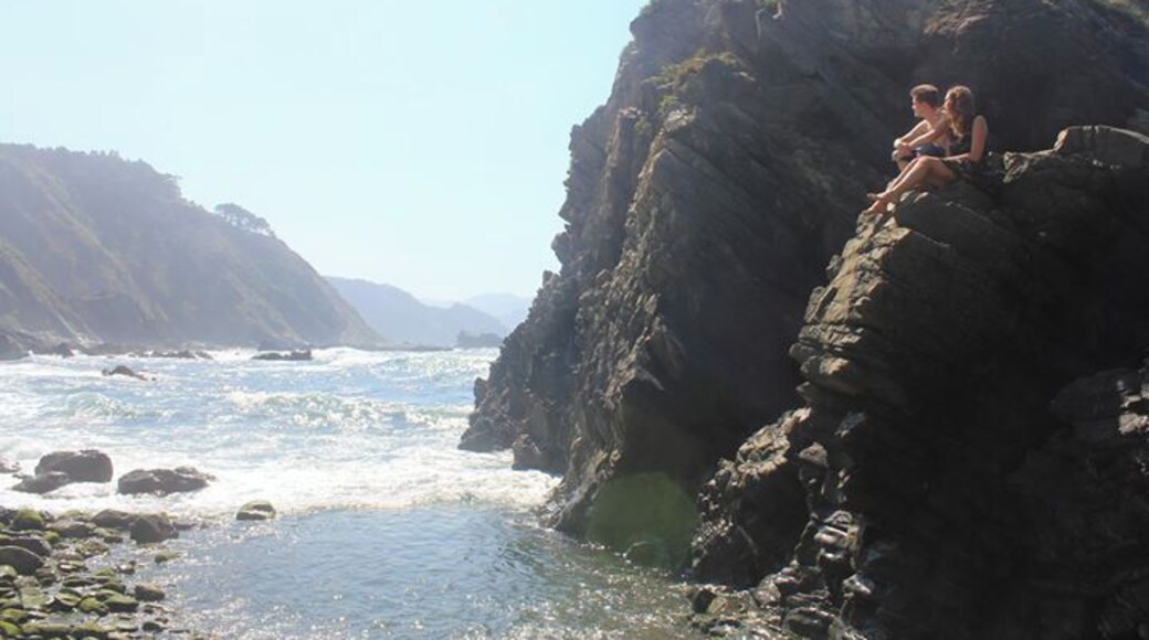 Walking over hard rocks, passing the tourists, you find this beautiful part of Asturias. It's hidden at the end of a rough path, but definitely worth it. Enjoy the view and sound of the waves crashing by climbing on a rock. It's very peaceful.