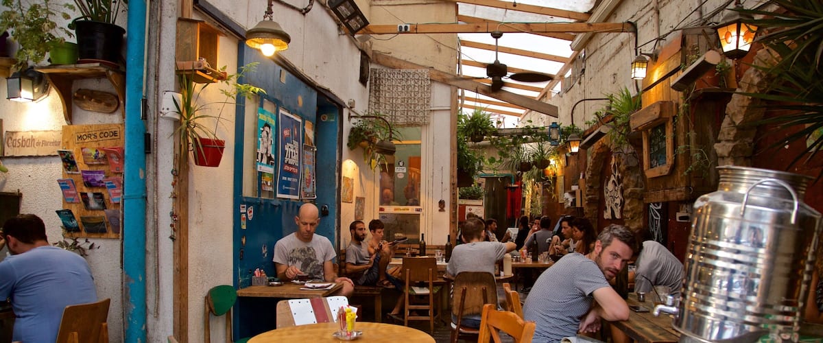 Florentin which includes outdoor eating as well as a large group of people
